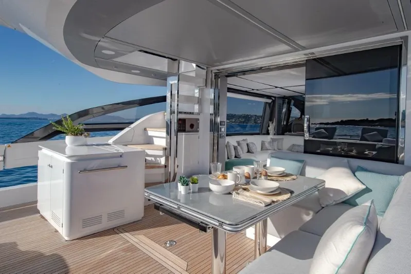  Yacht Photos Pics Luxurious 2023 Azimut S8 yacht deck with elegant dining setup and ocean view.