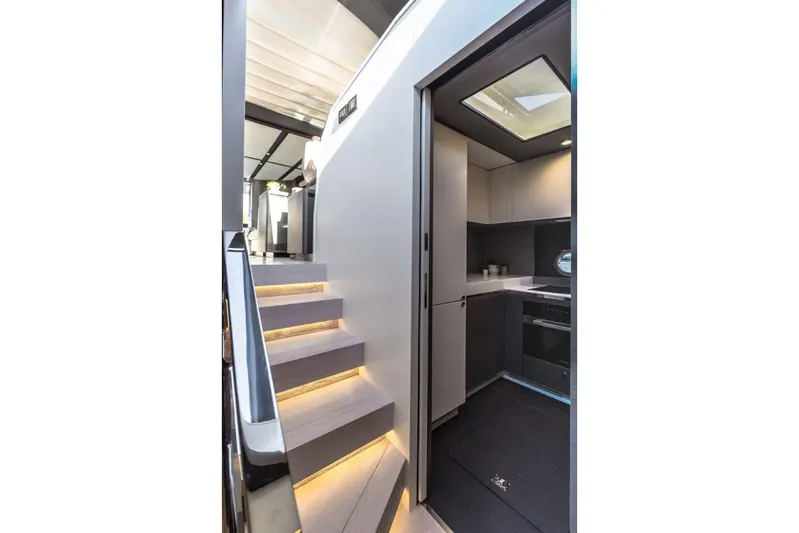  Yacht Photos Pics Interior of 2023 Azimut S8 yacht featuring modern kitchen and illuminated staircase.