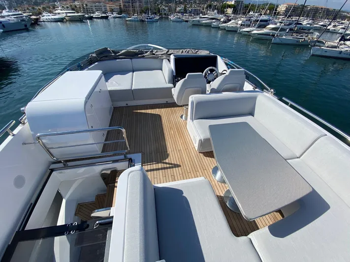  Yacht Photos Pics Luxurious 2023 Azimut S8 yacht deck with elegant seating and scenic marina view.