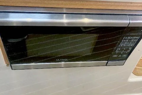 Tootles Yacht Photos Pics Microwave in 2016 Ranger Tugs R-31 boat interior, featuring control panel and wood trim.