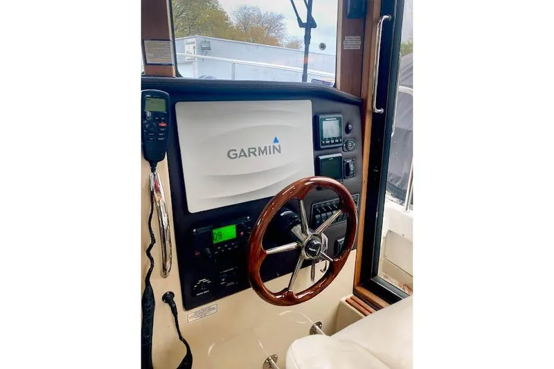 Tootles Yacht Photos Pics 2016 Ranger Tugs R-31 helm with Garmin navigation system and wooden steering wheel.