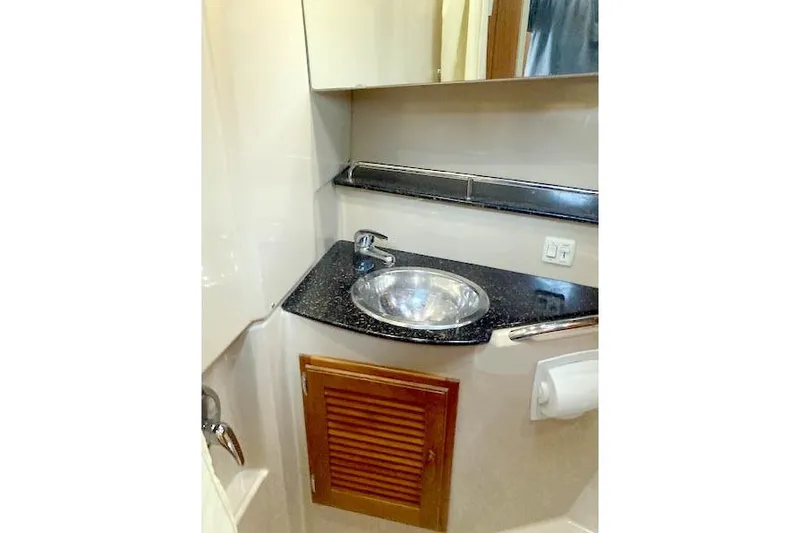 Tootles Yacht Photos Pics 2016 Ranger Tugs R-31 bathroom with sink, mirror, and storage cabinet.