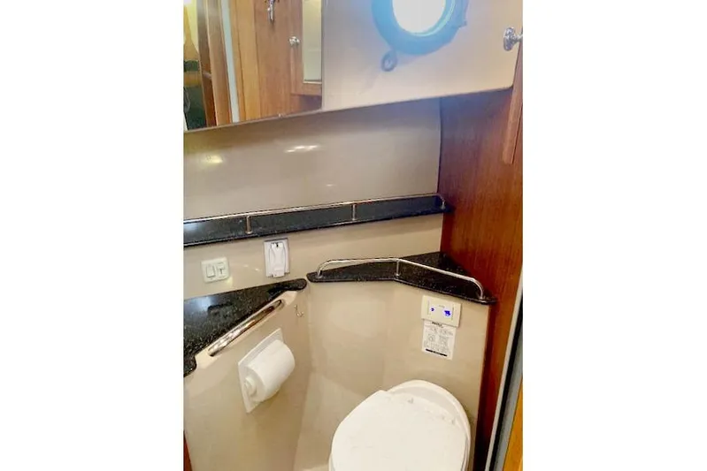 Tootles Yacht Photos Pics Bathroom interior of 2016 Ranger Tugs R-31 boat with porthole and modern fixtures.