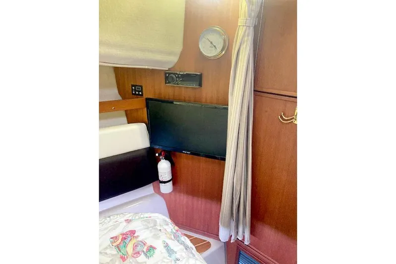 Tootles Yacht Photos Pics 2016 Ranger Tugs R-31 cabin interior with TV, fire extinguisher, and wood paneling.