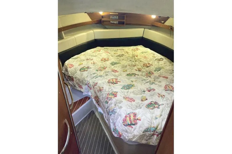 Tootles Yacht Photos Pics 2016 Ranger Tugs R-31 cabin interior with a cozy bed and nautical-themed bedding.