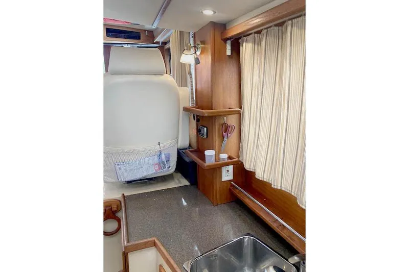 Tootles Yacht Photos Pics Interior of 2016 Ranger Tugs R-31 with wood accents and compact kitchen area.