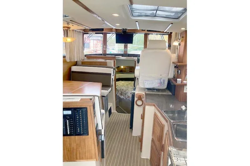 Tootles Yacht Photos Pics Interior of 2016 Ranger Tugs R-31 boat with seating, helm, and wood accents.