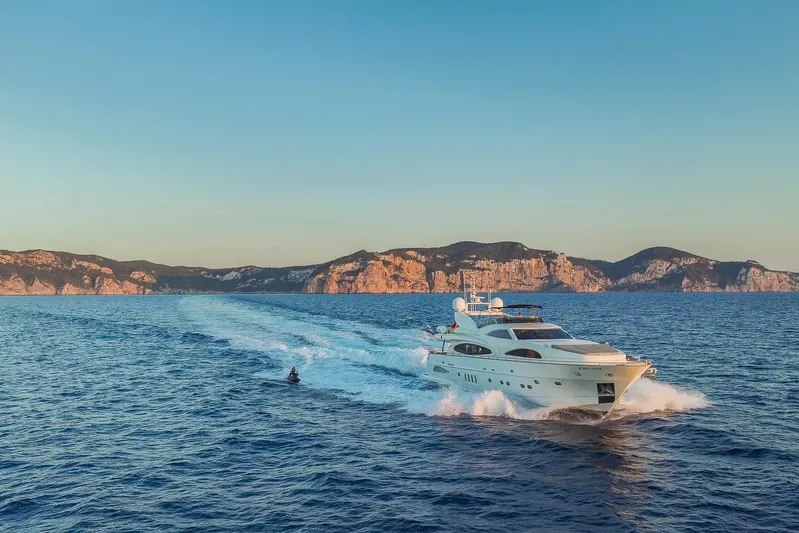  Yacht Photos Pics Astondoa 102 GLX yacht cruising on open sea with scenic coastal backdrop, 2005 model.