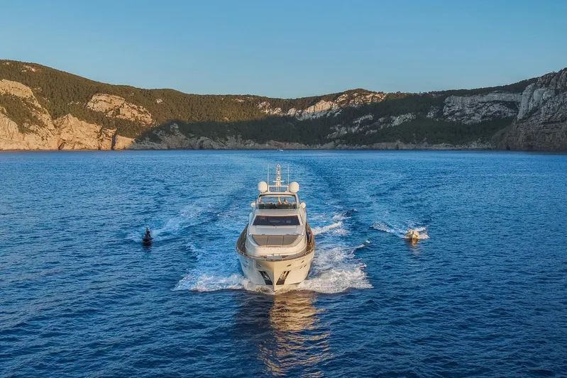  Yacht Photos Pics Astondoa 102 GLX yacht cruising on blue waters, scenic coastal backdrop, 2005 model.