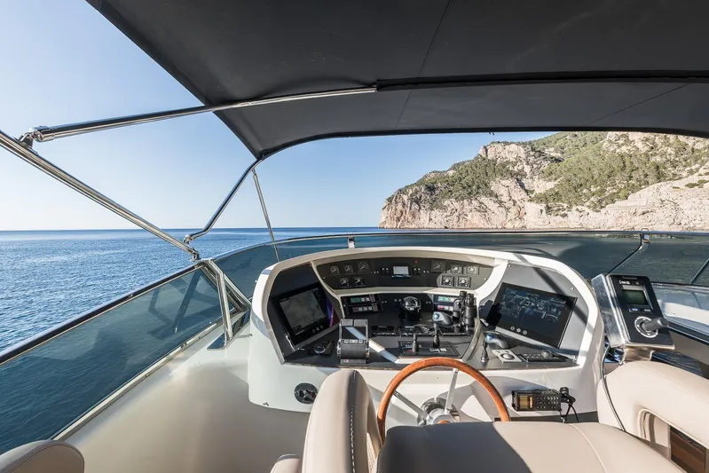  Yacht Photos Pics Helm of 2005 Astondoa 102 GLX yacht with ocean and cliff view.