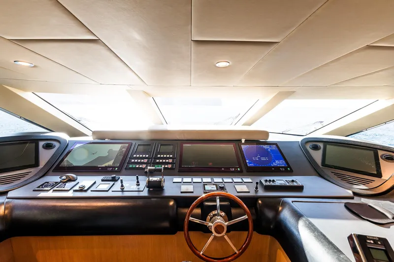  Yacht Photos Pics Control panel of 2005 Astondoa 102 GLX yacht with modern navigation equipment and steering wheel.