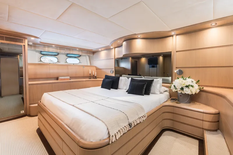  Yacht Photos Pics Luxurious bedroom interior of 2005 Astondoa 102 GLX yacht with elegant wood finish.