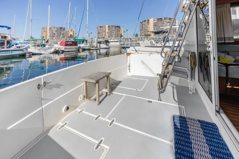 Honey Dew Yacht Photos Pics 2000 Sabre 34 Flybridge yacht deck with marina view, featuring ladder and seating.