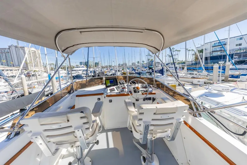 Honey Dew Yacht Photos Pics Flybridge view of 2000 Sabre 34 yacht in marina, featuring helm and seating.