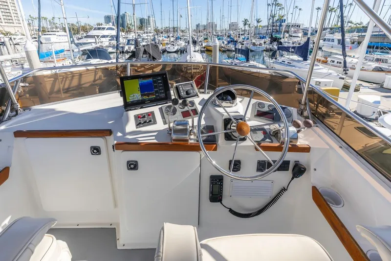 Honey Dew Yacht Photos Pics Flybridge helm of 2000 Sabre 34, featuring navigation equipment and marina view.