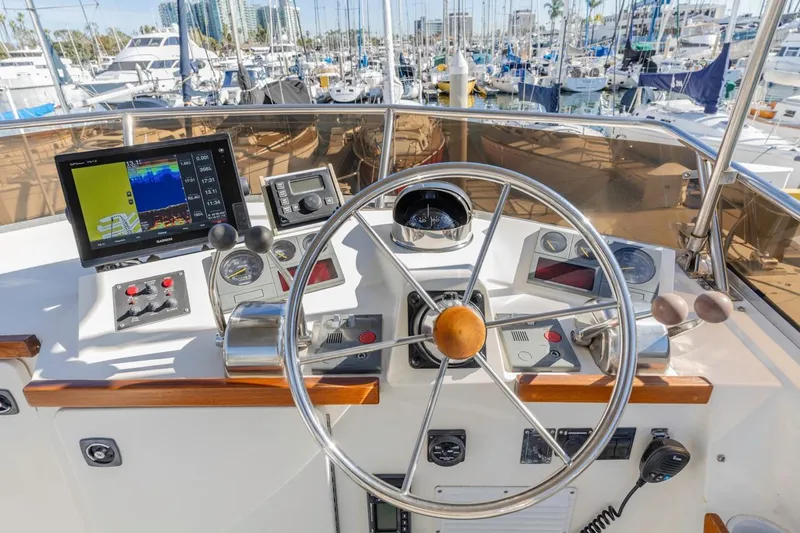 Honey Dew Yacht Photos Pics Helm of 2000 Sabre 34 Flybridge with navigation equipment and marina view.