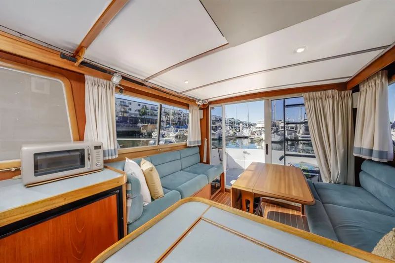 Honey Dew Yacht Photos Pics Interior of 2000 Sabre 34 Flybridge yacht with cozy seating and marina view.