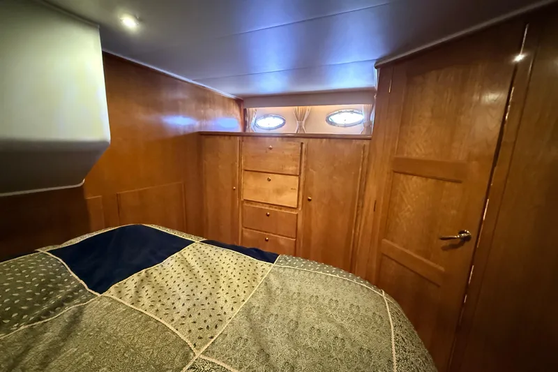 Hukilau Yacht Photos Pics Cozy cabin interior of 2003 Navigator 4800 yacht with wood paneling and bed.