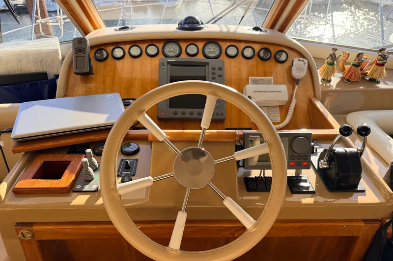 Hukilau Yacht Photos Pics 2003 Navigator 4800 yacht helm with steering wheel, controls, and navigation equipment.