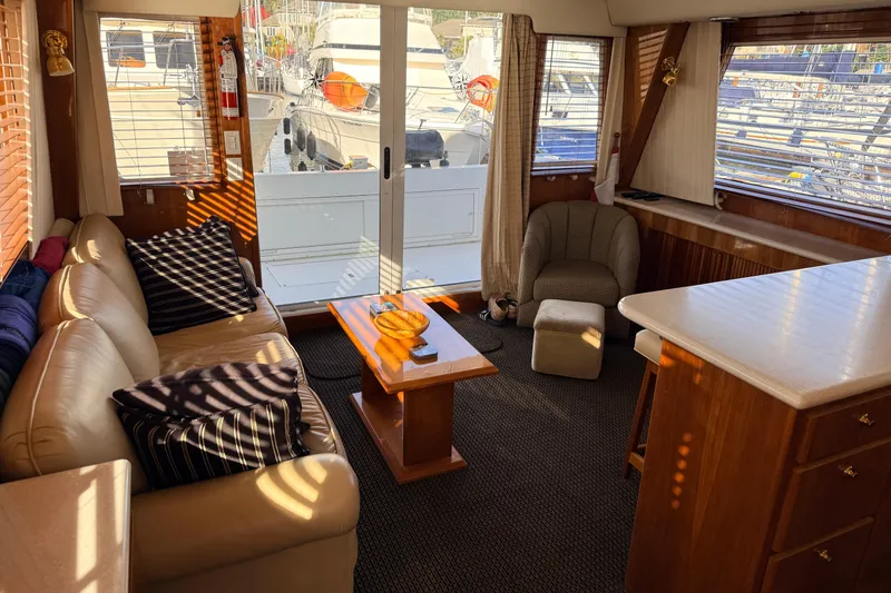 Hukilau Yacht Photos Pics Luxurious 2003 Navigator 4800 yacht interior with leather seating and wooden accents.