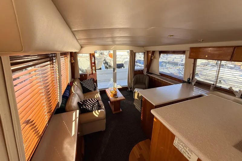 Hukilau Yacht Photos Pics Luxurious interior of 2003 Navigator 4800 yacht with elegant seating and wooden accents.