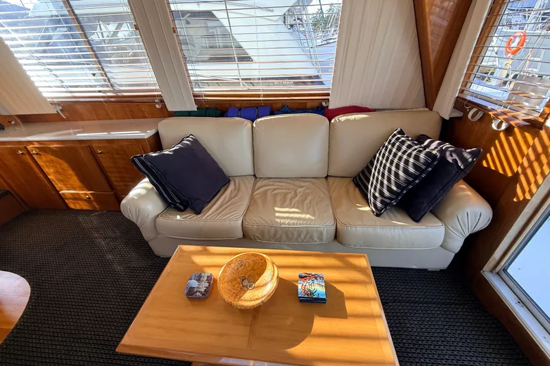 Hukilau Yacht Photos Pics Interior of 2003 Navigator 4800 yacht with beige sofa and decorative pillows.