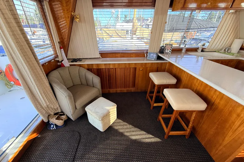 Hukilau Yacht Photos Pics Cozy interior of 2003 Navigator 4800 yacht with seating and wooden accents.