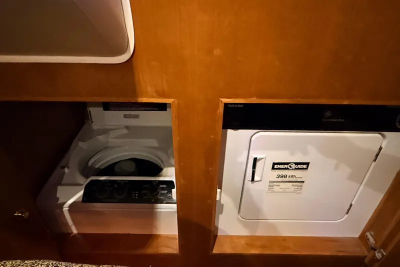 Hukilau Yacht Photos Pics Laundry appliances in 2003 Navigator 4800 yacht interior, featuring washer and dryer units.