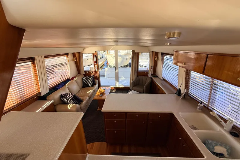 Hukilau Yacht Photos Pics Luxurious interior of 2003 Navigator 4800 yacht with elegant wood finishes and comfortable seating.