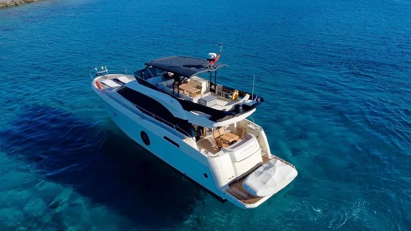 Anahita Yacht Photos Pics 2015 Beneteau Monte Carlo 6 yacht cruising in clear blue waters.