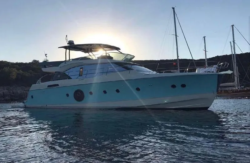 Anahita Yacht Photos Pics 2015 Beneteau Monte Carlo 6 yacht on calm water at sunset.