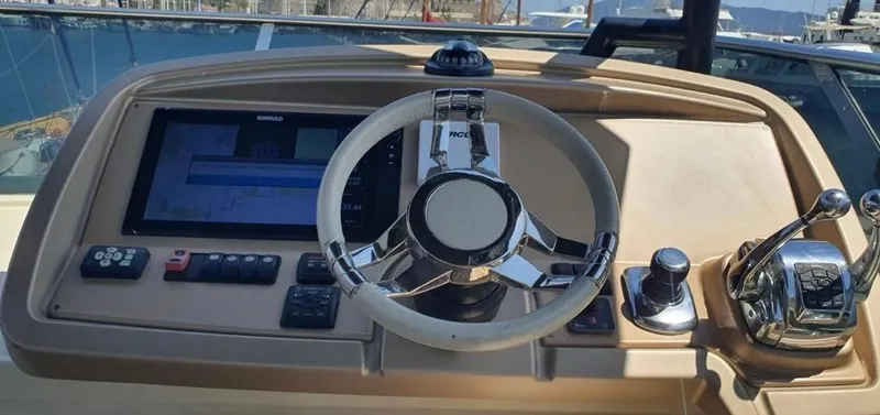 Anahita Yacht Photos Pics Helm of 2015 Beneteau Monte Carlo 6 yacht with steering wheel and control panel.