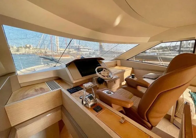 Anahita Yacht Photos Pics Luxurious interior of 2015 Beneteau Monte Carlo 6 yacht with helm station and panoramic windows.