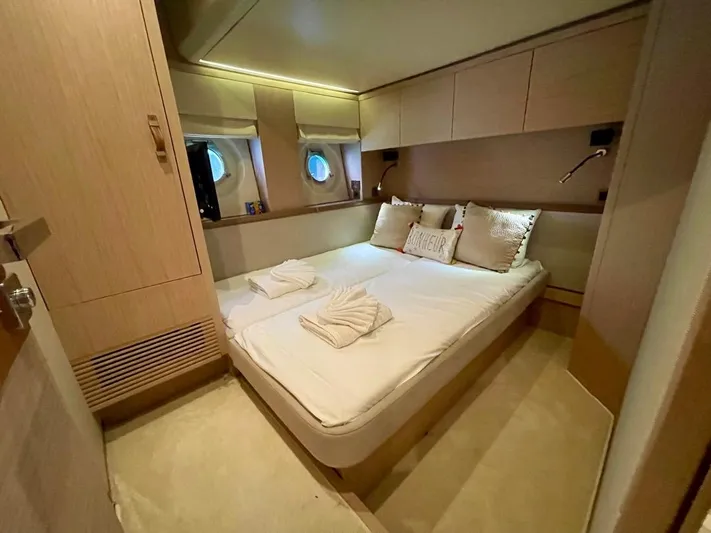 Anahita Yacht Photos Pics Luxurious cabin interior of 2015 Beneteau Monte Carlo 6 yacht with cozy bed and porthole windows.