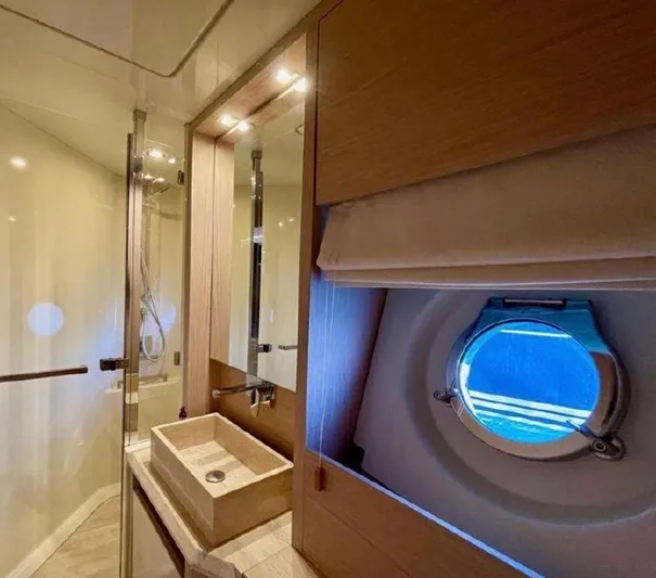 Anahita Yacht Photos Pics Luxurious bathroom in 2015 Beneteau Monte Carlo 6 yacht with porthole and modern fixtures.