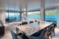 Luxurious interior of 2023 Custom Line Navetta 30 yacht with elegant dining and ocean views.