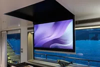 Luxurious interior of 2023 Custom Line Navetta 30 yacht with modern TV and sea view.