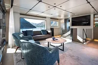Luxurious interior of 2023 Custom Line Navetta 30 yacht with modern seating and scenic views.