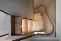 Spiral staircase on Custom Line Navetta 30 yacht, 2023 model, with elegant wood finish.