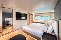 Luxurious bedroom interior of 2023 Custom Line Navetta 30 yacht with modern design and large window.
