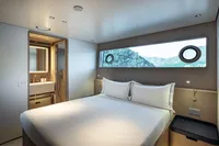 Luxurious cabin interior of 2023 Custom Line Navetta 30 yacht with scenic window view.