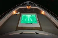 Luxurious 2023 Custom Line Navetta 30 yacht with illuminated jacuzzi on deck at night.