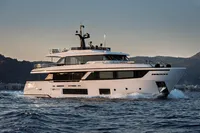 2023 Custom Line Navetta 30 yacht cruising on open water at sunset.