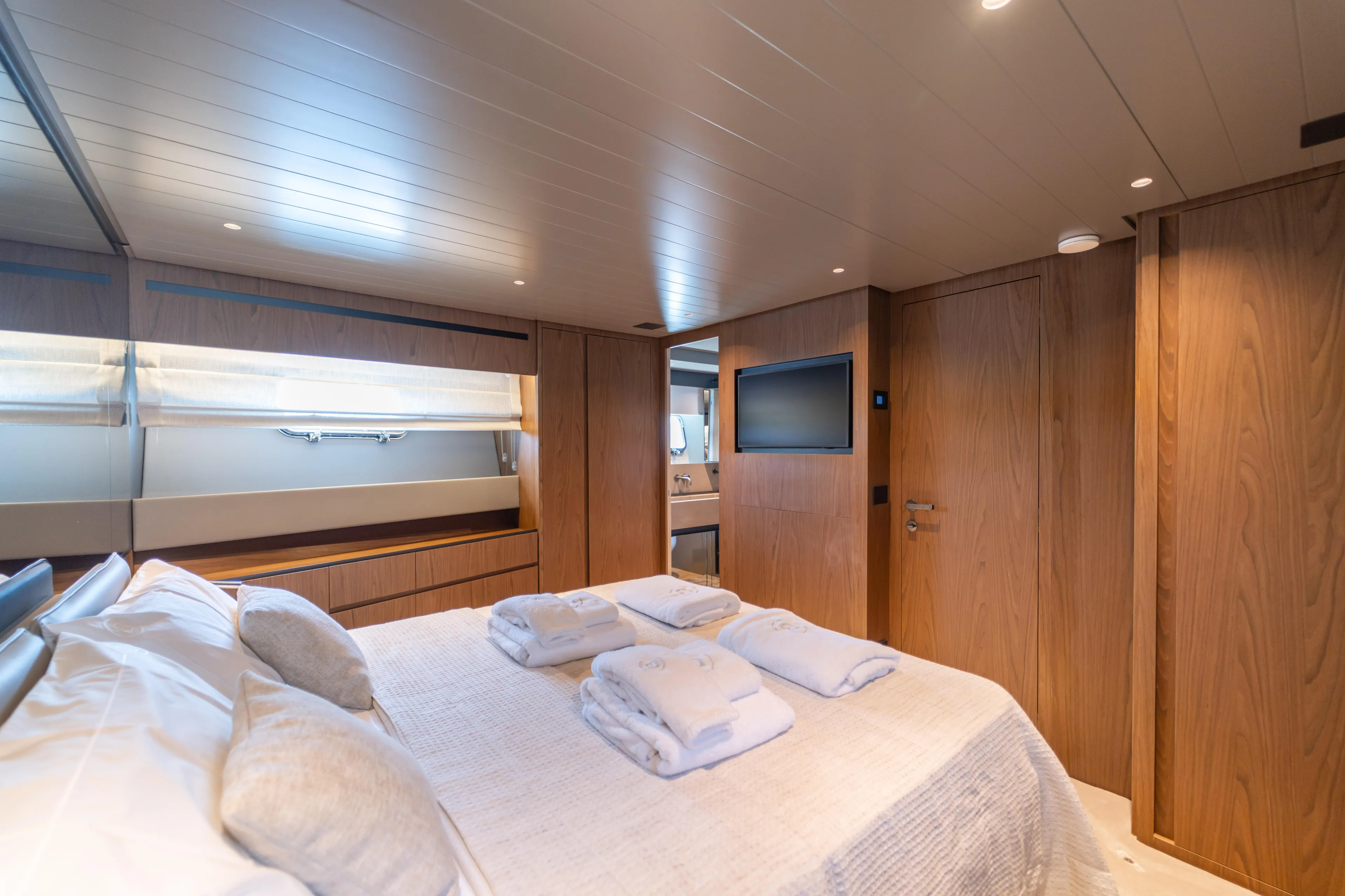  Yacht Photos Pics Luxurious cabin interior of 2025 Bluegame BG74 yacht with modern wood finishes.