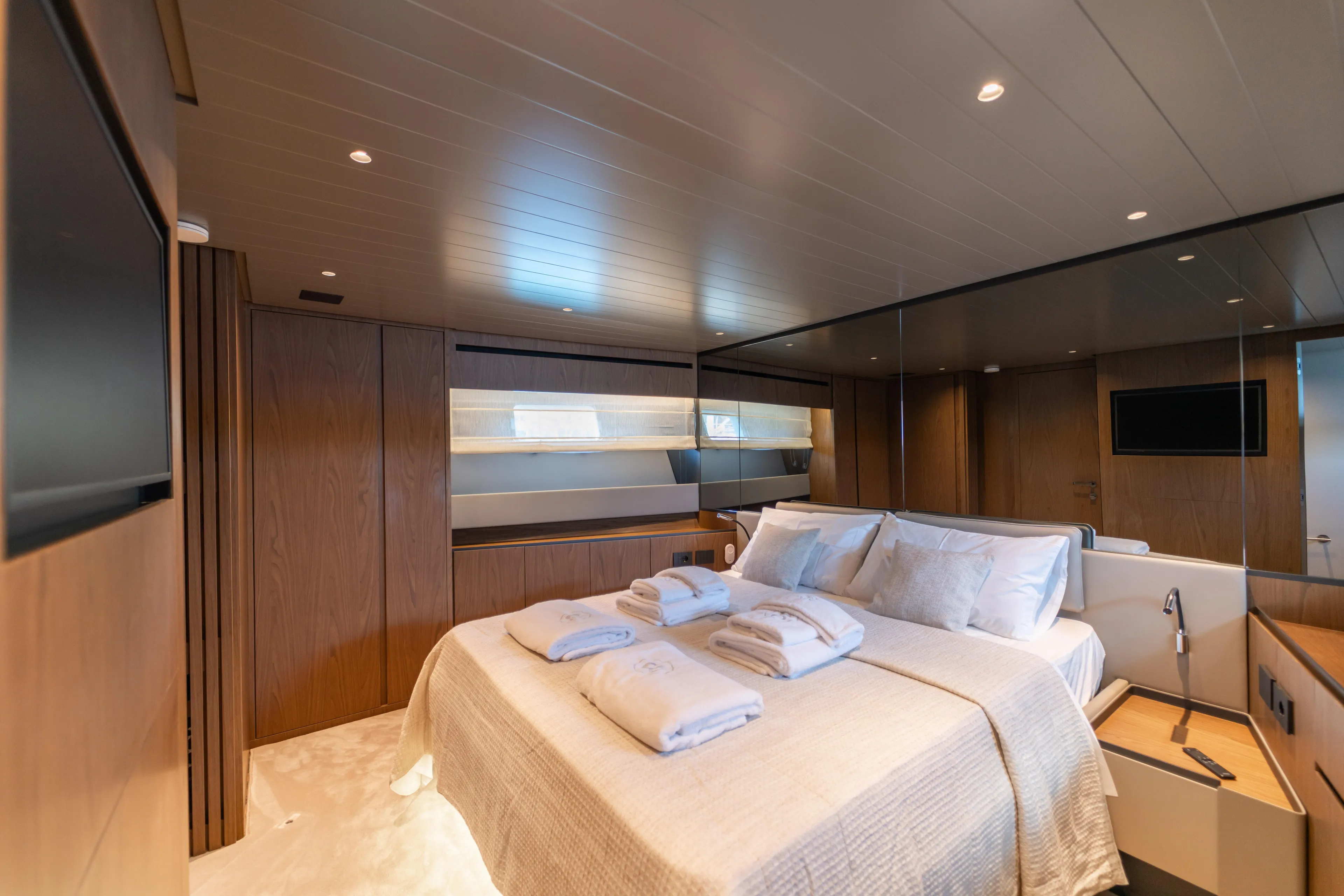  Yacht Photos Pics Luxurious bedroom interior of 2025 Bluegame BG74 yacht, featuring modern design and cozy ambiance.