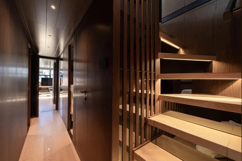  Yacht Photos Pics Luxurious interior of 2025 Bluegame BG74 yacht with modern wooden staircase and hallway.