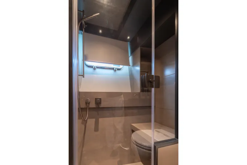  Yacht Photos Pics Modern bathroom interior on 2025 Bluegame BG74 yacht, featuring sleek shower and toilet design.