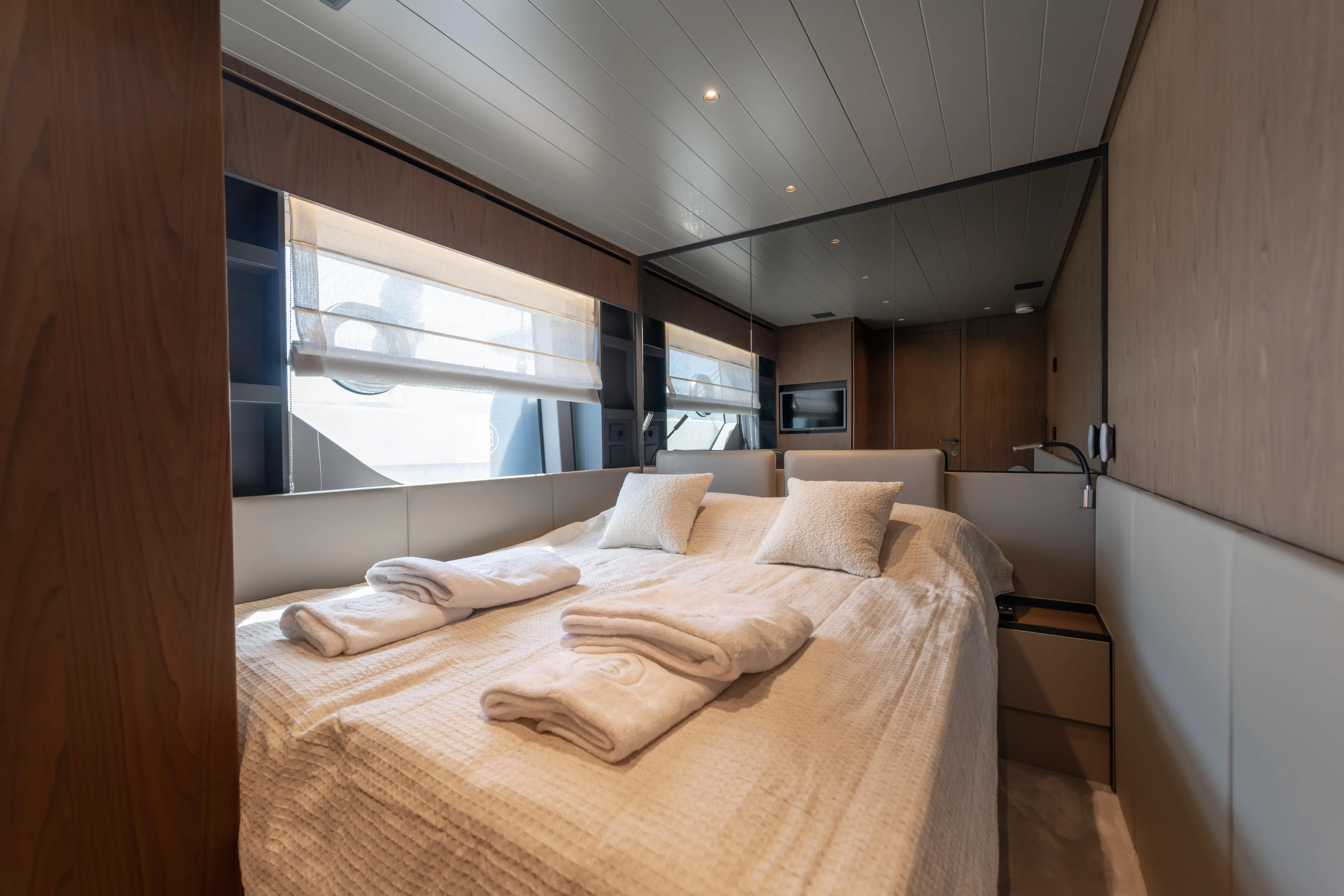  Yacht Photos Pics Luxurious interior cabin of 2025 Bluegame BG74 yacht with cozy bedding and modern design.
