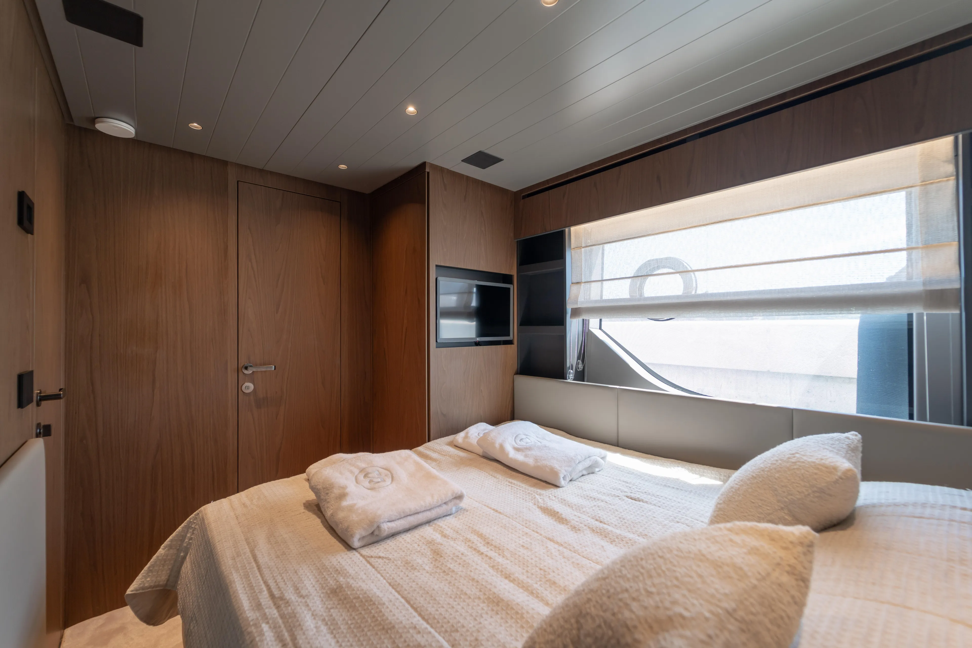  Yacht Photos Pics Luxurious cabin interior of 2025 Bluegame BG74 yacht with modern design and cozy bedding.