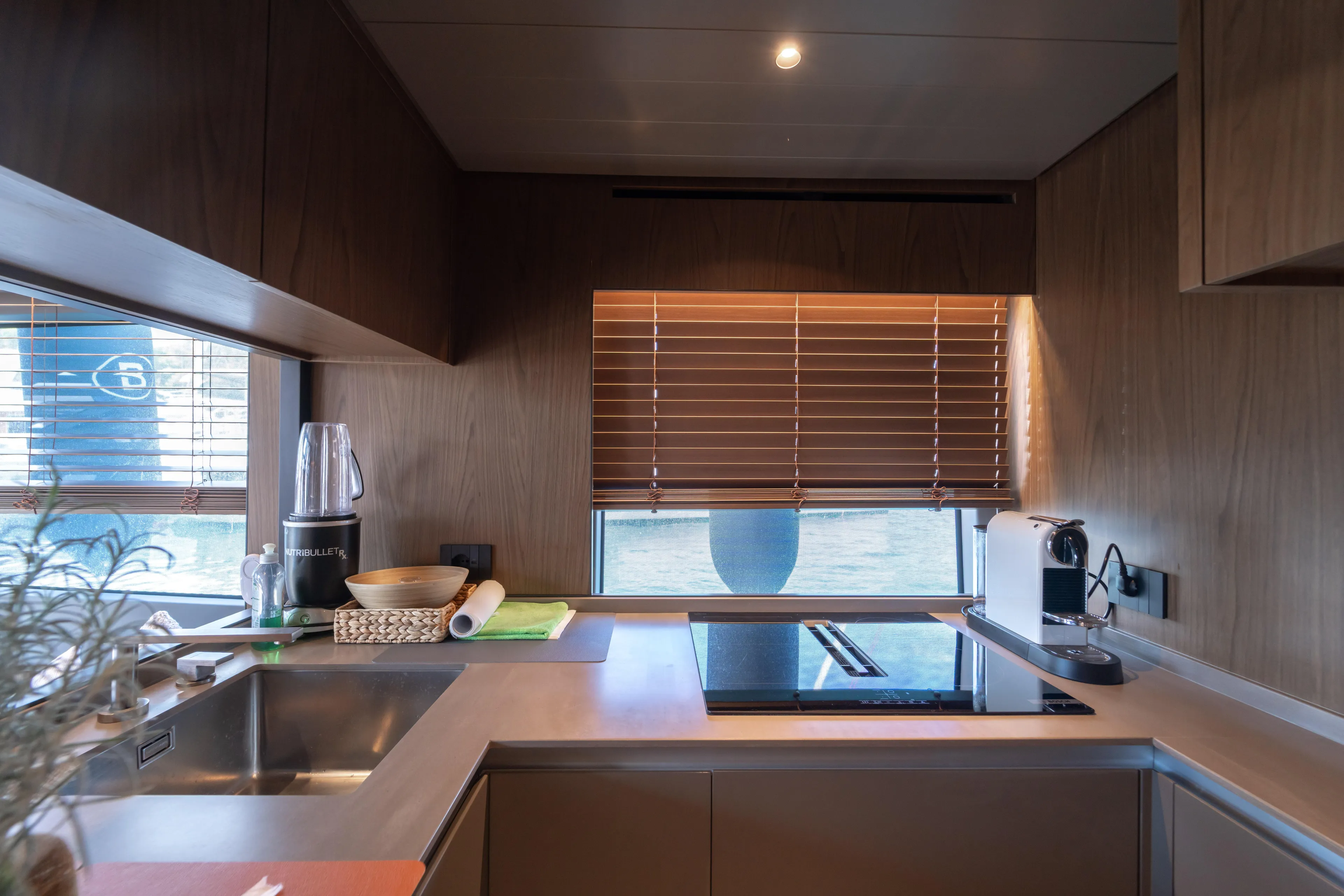  Yacht Photos Pics Modern kitchen interior on 2025 Bluegame BG74 yacht with wooden cabinetry and appliances.
